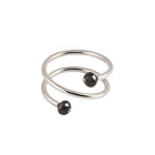 A white gold wrap ring featuring two faceted black gemstone beads at the ends of its open spiral design, set against a plain white background.