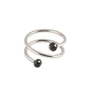 A white gold wrap ring featuring two faceted black gemstone beads at the ends of its open spiral design, set against a plain white background.