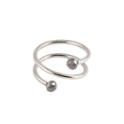 A white gold wrap ring featuring two faceted black gemstone beads at the ends of its open spiral design, set against a plain white background.