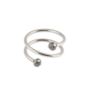A white gold wrap ring featuring two faceted black gemstone beads at the ends of its open spiral design, set against a plain white background.