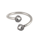 A gold open cuff ring featuring two faceted gray diamonds, photographed on a clean white background.