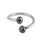 A gold open cuff ring featuring two faceted gray diamonds, photographed on a clean white background.