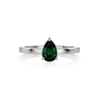 A white gold ring featuring a faceted pear-cut tourmaline gemstone in a three-prong setting, displayed on a clean white background with a soft reflection.