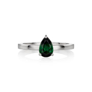 A white gold ring featuring a faceted pear-cut tourmaline gemstone in a three-prong setting, displayed on a clean white background with a soft reflection.