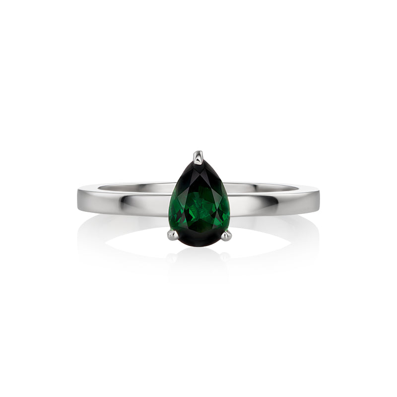 A white gold ring featuring a faceted pear-cut tourmaline gemstone in a three-prong setting, displayed on a clean white background with a soft reflection.