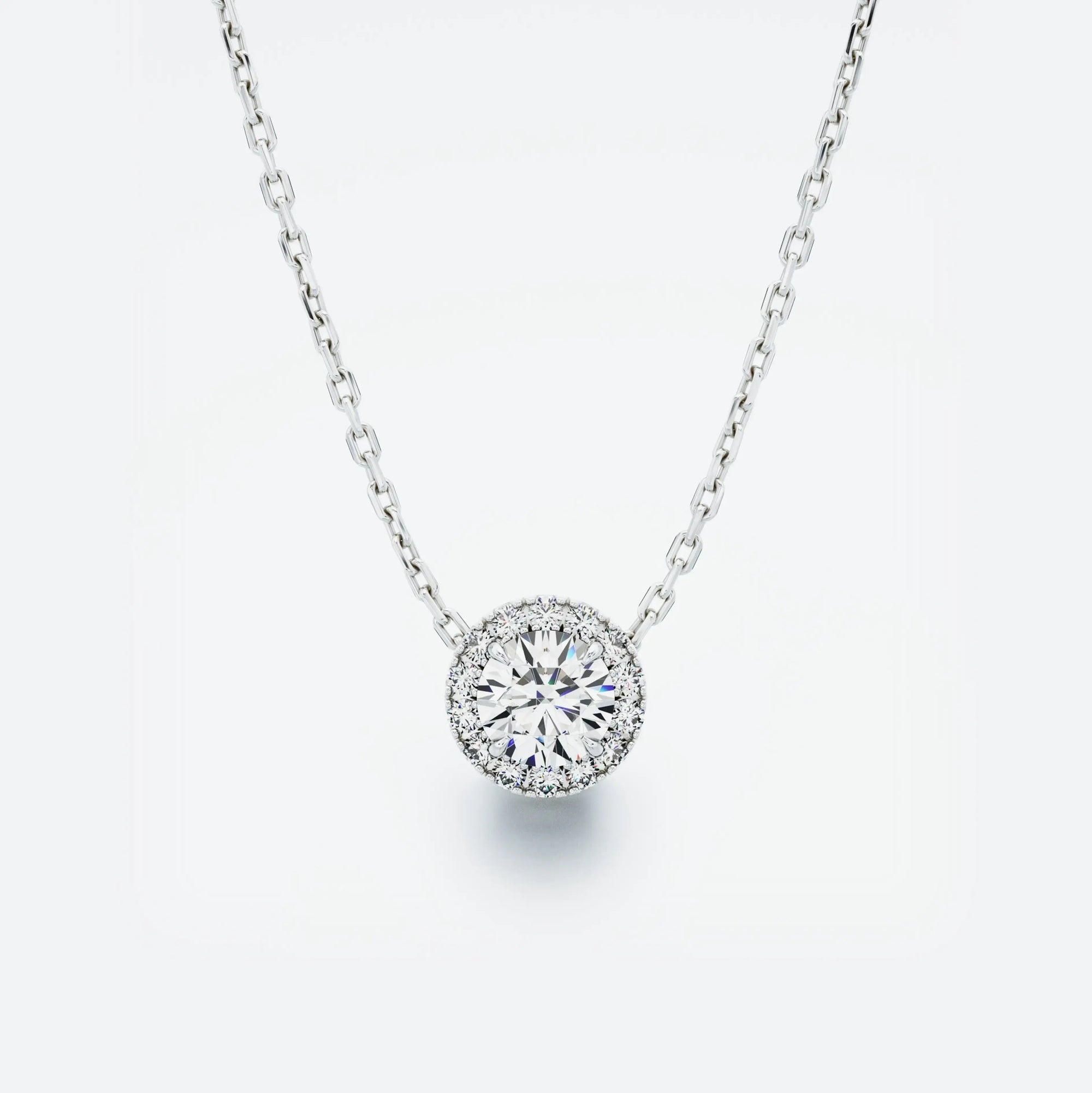 Halo Diamond Pendant featuring a central diamond surrounded by a sparkling halo, with a total carat weight of 0.40 ct.