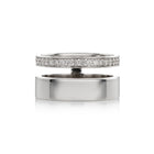 A polished white gold ring shown open, with one half featuring a row of clear pavé stones and the other half plain, on a white background.