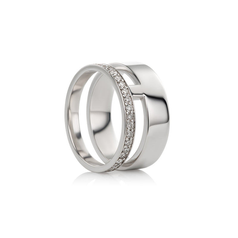 A swhite gold double-band ring with a central channel set with small clear stones, shown on a clean white background.