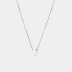 White gold heart-shaped pendant necklace on a light gray background