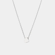 White gold heart-shaped pendant necklace on a light gray background