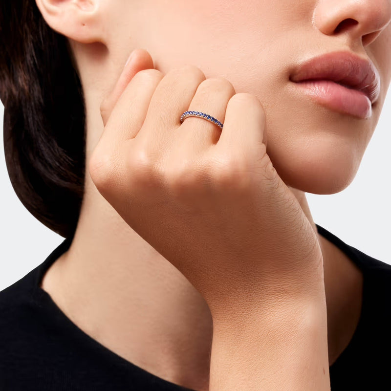 Close-up of a woman's hand wearing a ring with a white background