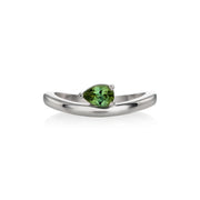 White gold ring featuring a pear-cut tourmaline in a prong setting, shown on a clean white background with a soft reflection.
