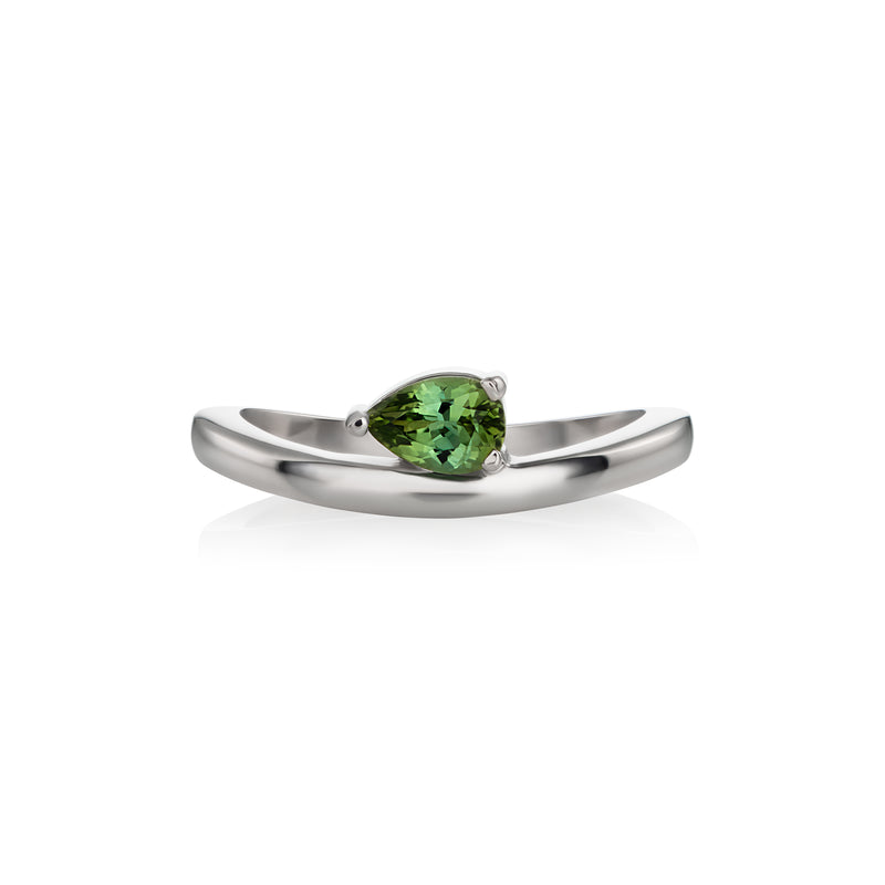 White gold ring featuring a pear-cut tourmaline in a prong setting, shown on a clean white background with a soft reflection.