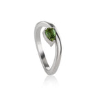 White gold ring featuring a pear-cut tourmaline in a prong setting, shown on a clean white background with a soft reflection.