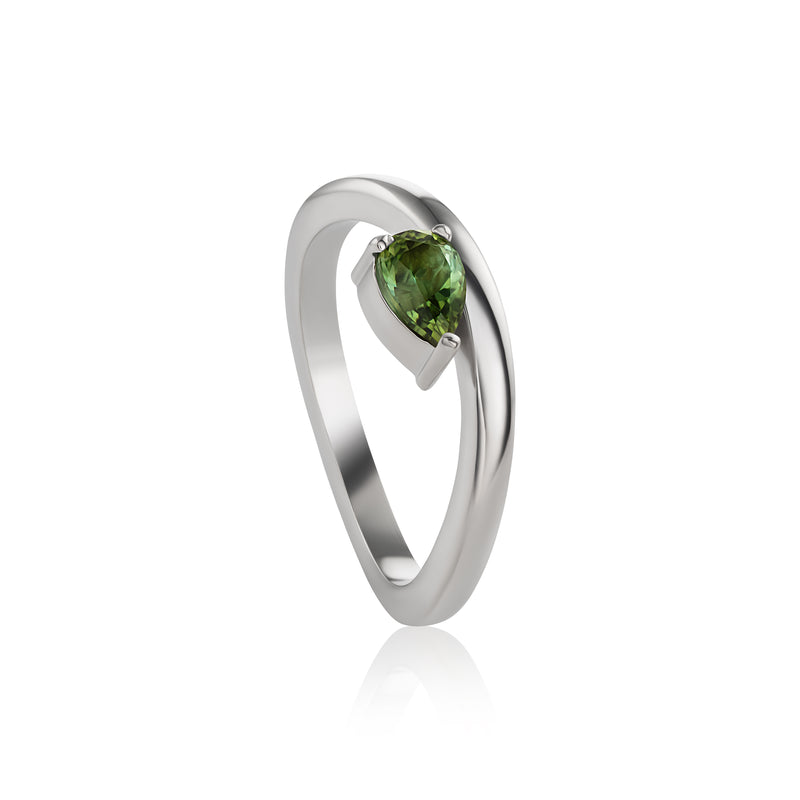 White gold ring featuring a pear-cut tourmaline in a prong setting, shown on a clean white background with a soft reflection.