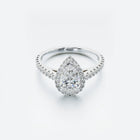 Diamond ring with a pear-shaped center stone on a white background