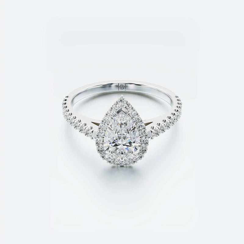 Diamond ring with a pear-shaped center stone on a white background