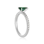 White gold ring with pear-shaper tourmaline and lined with pavé diamonds.