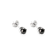 A pair of white gold stud earrings with faceted black diamonds, shown on a clean white background.