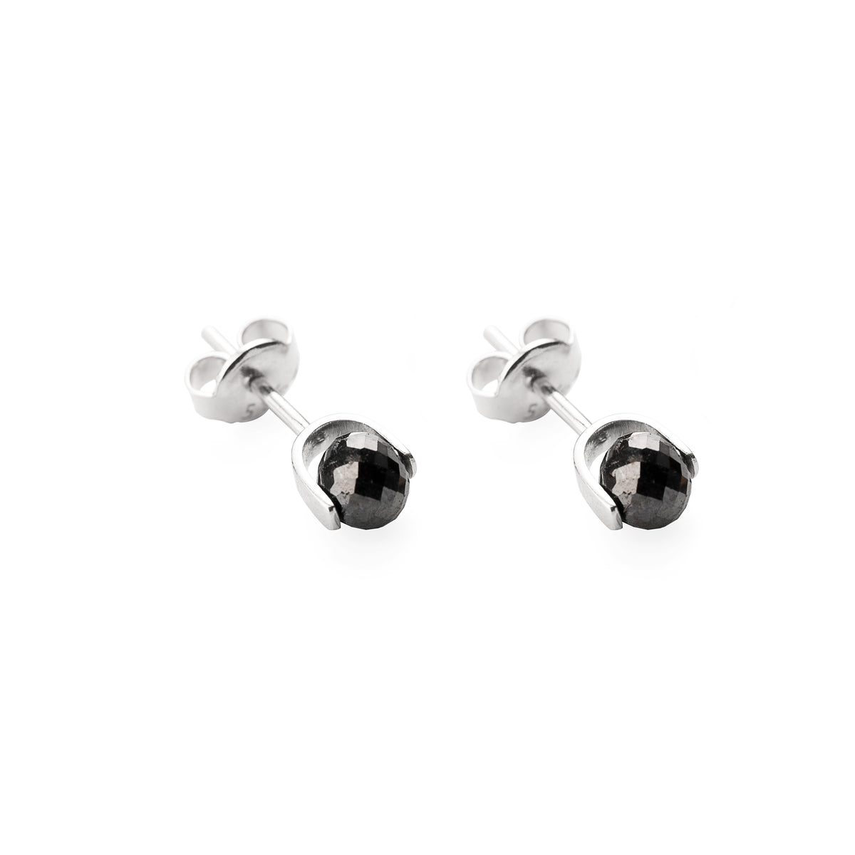 A pair of white gold stud earrings with faceted black diamonds, shown on a clean white background.
