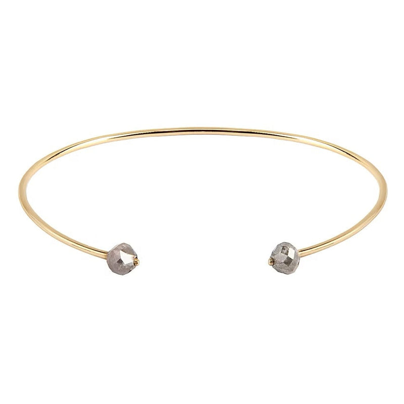 A thin gold open cuff bangle bracelet with two small faceted gray diamonds at the ends, shown on a plain white background.