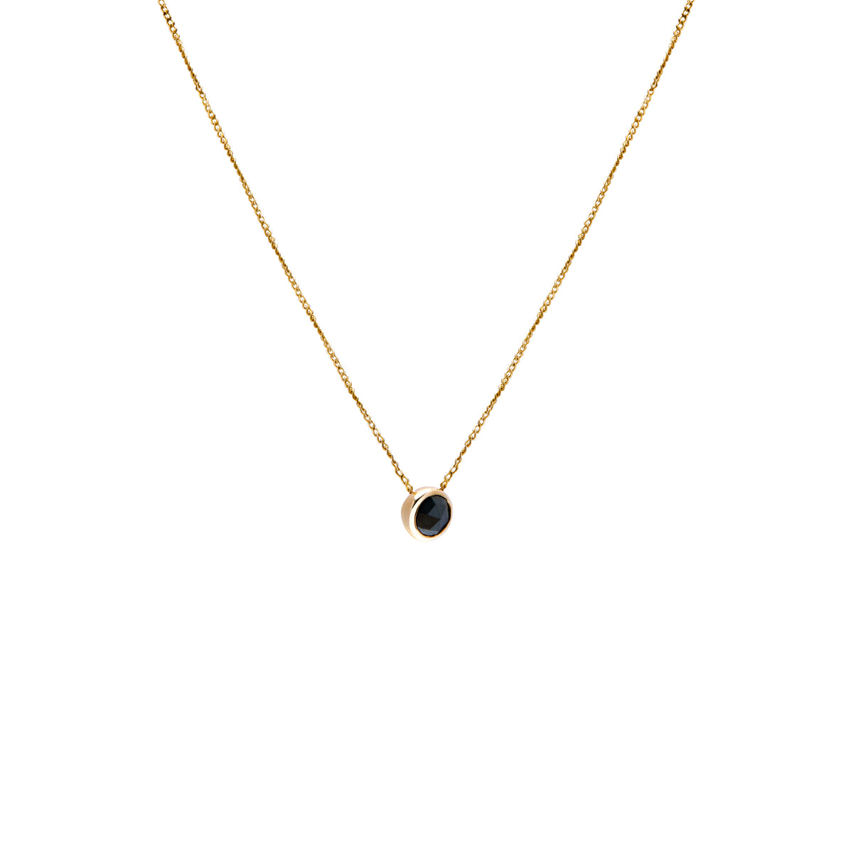 A delicate gold chain necklace with a small bezel-set ocean blue diamond pendant, shown against a plain white background.