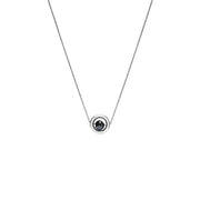 A delicate white gold chain necklace featuring a small circular pendant with a gold outer ring and a dark, nearly black, faceted diamond, shown against a plain white background.