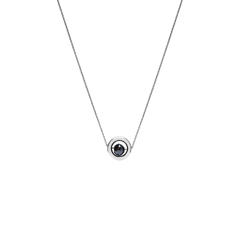 A delicate white gold chain necklace featuring a small circular pendant with a gold outer ring and a dark, nearly black, faceted diamond, shown against a plain white background.