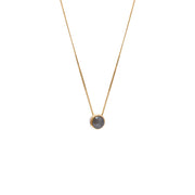 A delicate gold chain necklace with a small bezel-set rose-cut grey diamond pendant, shown against a plain white background.