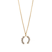 Yellow gold necklace with a faceted grey diamonds pendant on a white background.