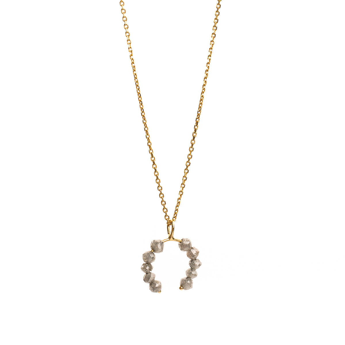 Yellow gold necklace with a faceted grey diamonds pendant on a white background.