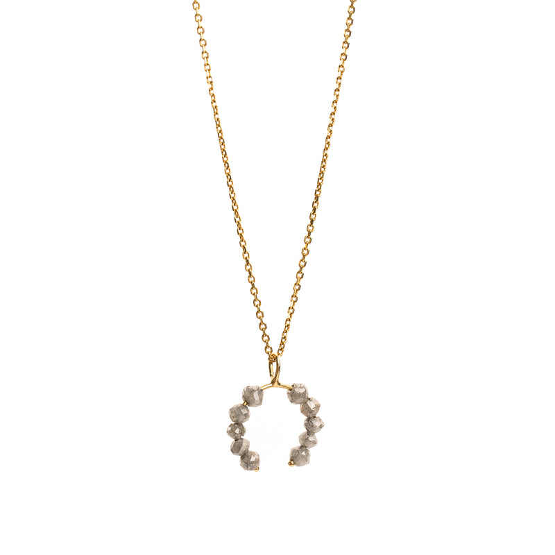 Yellow gold necklace with a faceted grey diamonds pendant on a white background.