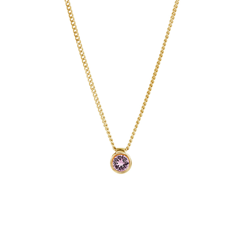 A delicate gold chain necklace featuring a small round bezel-set pendant with a faceted light purple sapphire, shown against a plain white background.