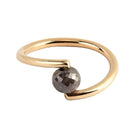 A yellow gold open wrap ring featuring a faceted black diamond, shown on a plain white background.
