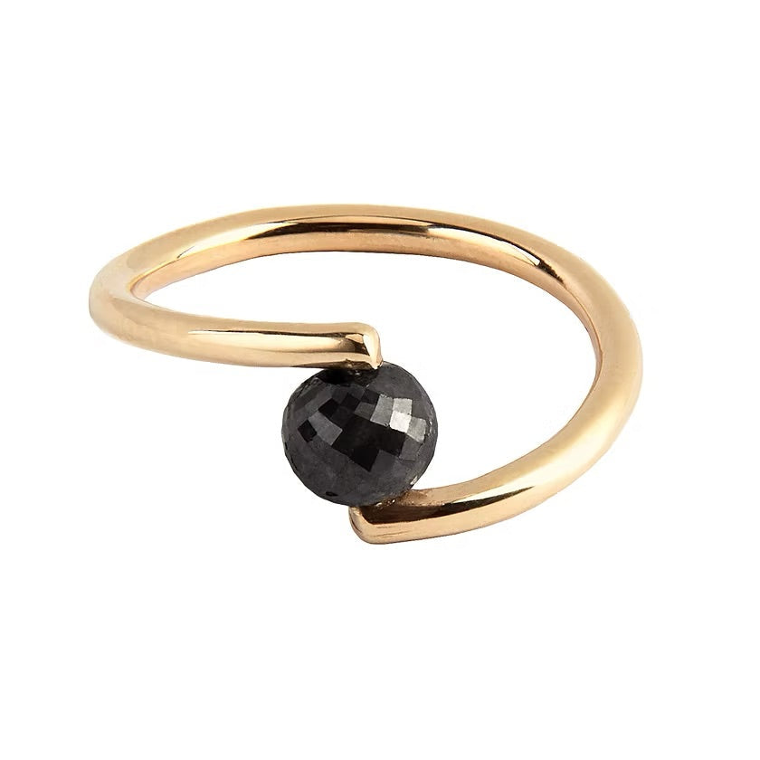 A yellow gold open wrap ring featuring a faceted black diamond, shown on a plain white background.
