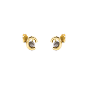 A pair of gold crescent-shaped stud earrings with round grey diamonds, shown on a plain white background.