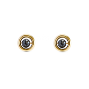 A pair of yellow gold stud earrings with a central faceted black diamond, set against a plain white background.
