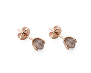 A pair of gold stud earrings with faceted gray diamonds in a prong setting, shown on a clean white background.