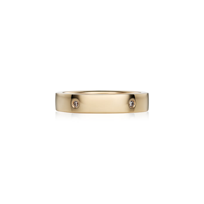 A slim yellow gold band ring with small brilliant diamonds set along it, photographed on a clean white background.