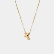 Yellow gold necklace with a small cross pendant on a white background