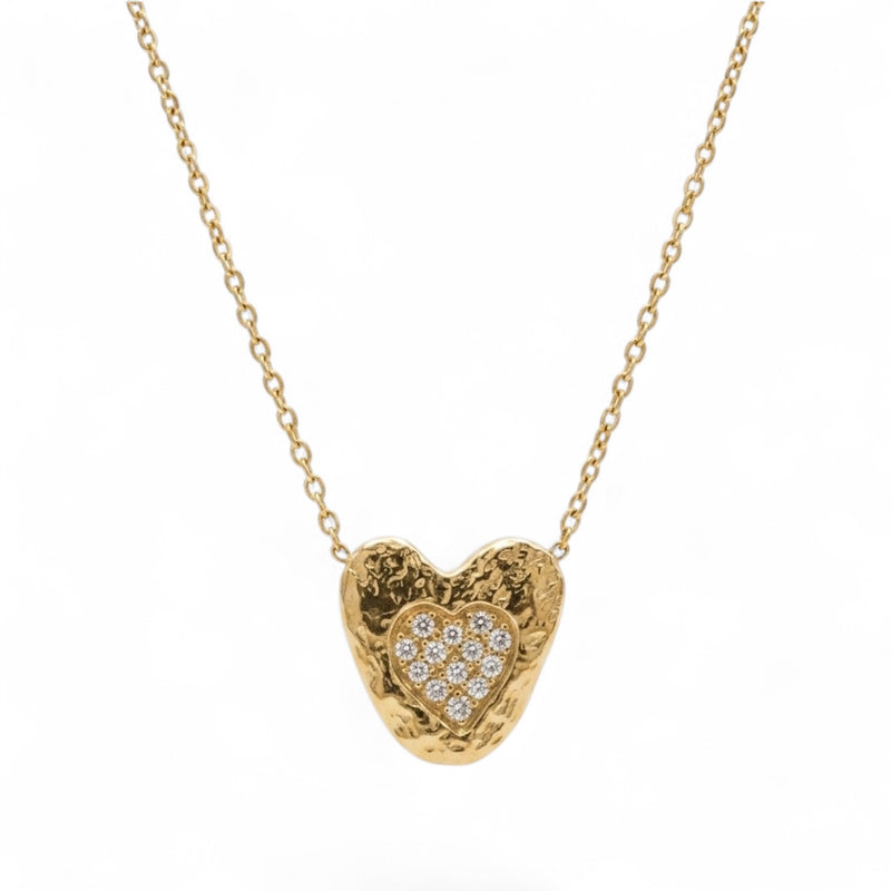 Gold heart-shaped necklace with embedded diamonds on a white background