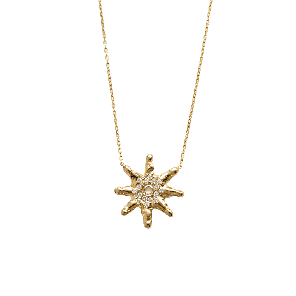 Gold star-shaped necklace with embedded diamonds on a white background