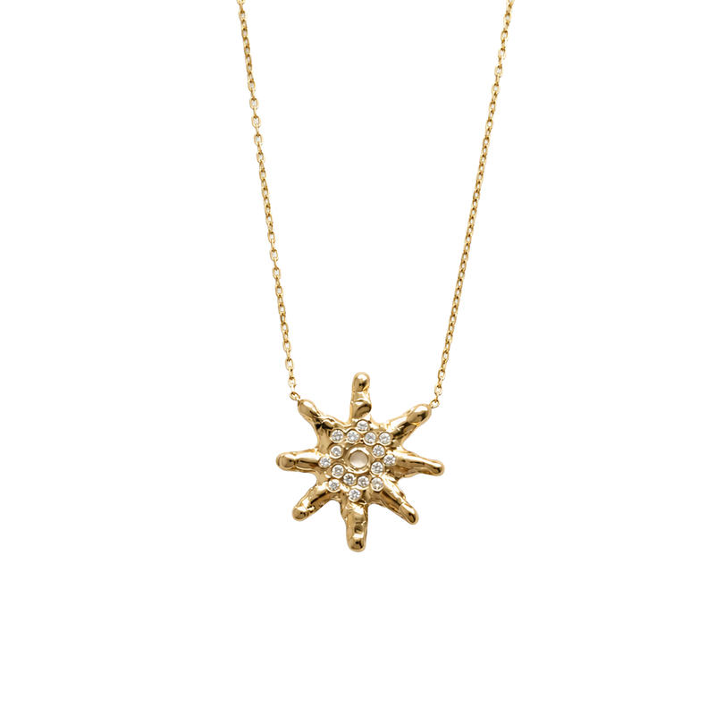 Gold star-shaped necklace with embedded diamonds on a white background