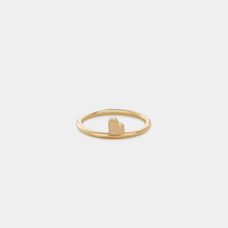 Yellow gold ring with a heart-shaped detail.