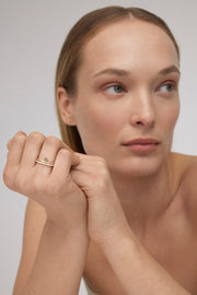 Yellow gold ring with a heart-shaped detail.