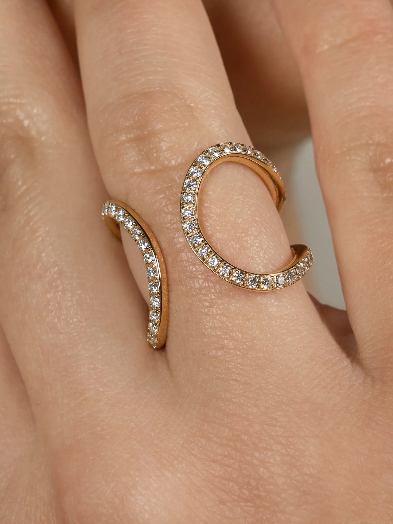 A yellow gold ring and ear cuff featuring a series of lab grown diamonds set in recycled 18k yellow gold, with a total of 86 diamonds.