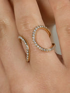 A yellow gold ring and ear cuff featuring a series of lab grown diamonds set in recycled 18k yellow gold, with a total of 86 diamonds.