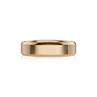 A polished yellow gold band ring with a smooth, slightly beveled edge, shown on a clean white background with a soft reflection underneath.