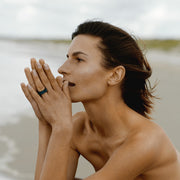 Woman with a one-of-a-kind ring composed of niobium and black tourmaline by ASR JWLS.