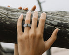 Close-up of a hand wearing a one-of-a-kind ring composed of tantalum and rough tourmaline by ASR JWLS.